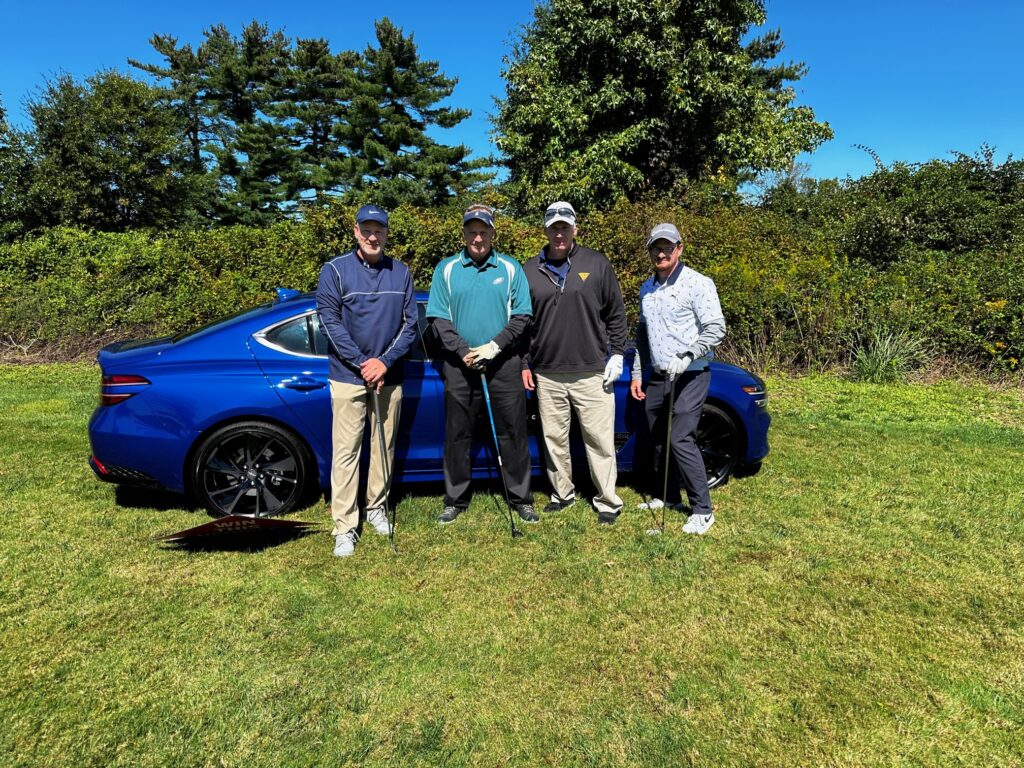 Foursome lines up a putt during the SJBA Paws Healing Heroes Charity Golf Tournament at Indian Spring Country Club, showcasing community impact and networking